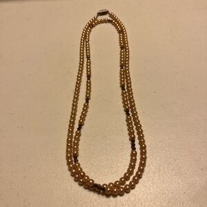 Costume jewelry tan/brown long necklace Can be doubled up. Has magnetic clip